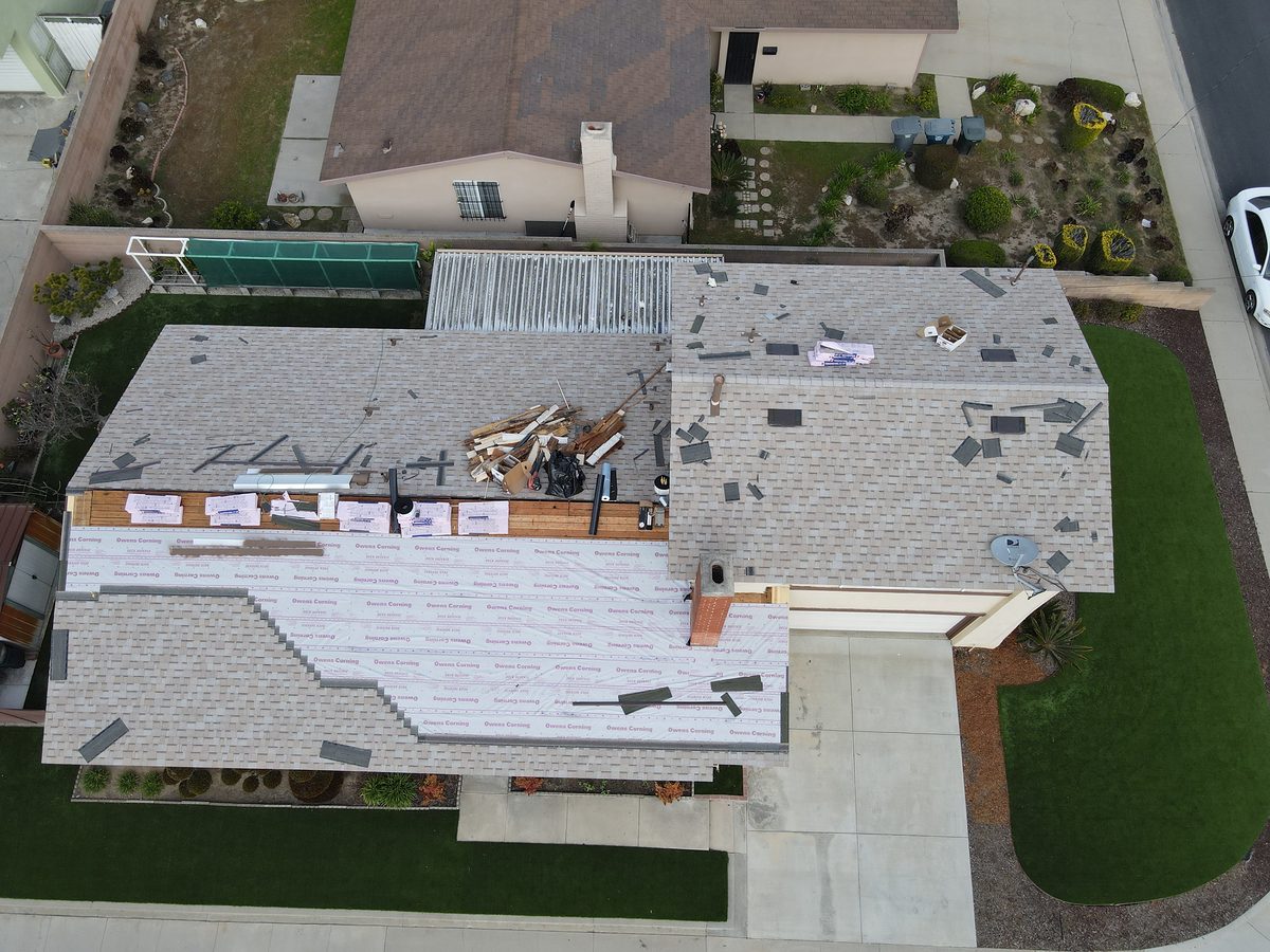 New asphalt shingles being installed by Elite Upgrades crew